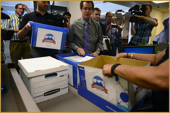 DENVER, CO - August 12, 2016: Marijuana activist Emmett Reistroffer and cannabis consultant Kayvan Khalatbari hand deliver more than 10,800 signatures for a public cannabis use ballot initiative to the Denver Elections officials. Backers of a Denver initiative that would allow adults to consume cannabis in regulated, neighborhood-approved consumption spaces submit a petition to city officials on Friday, August 12, 2016 with more than twice the number of voter signatures needed to qualify for the November ballot. (Photo by Vince Chandler / The Denver Post)