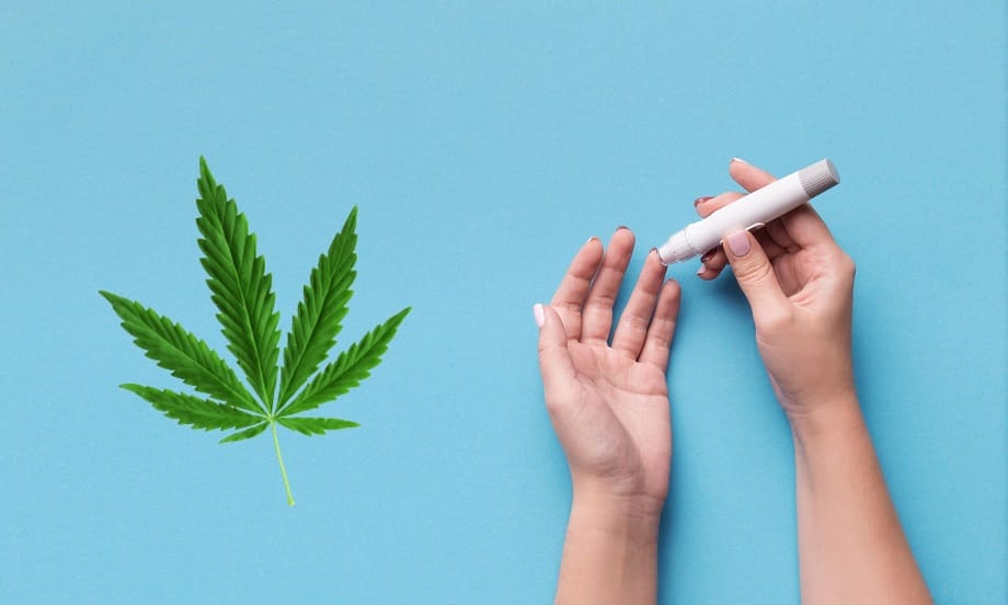 woman using glucometer on blue background top QPW9EVN