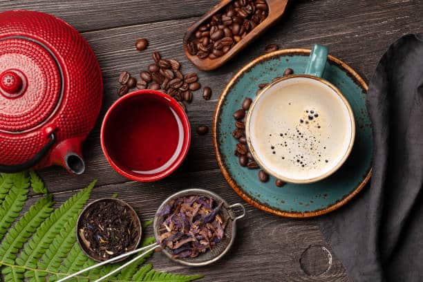 various herbal tea and espresso coffee on wooden table. top view. flat lay
