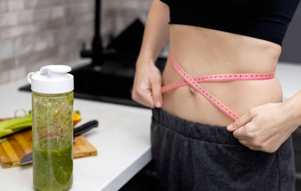 woman doing healthy smoothie at kitchen